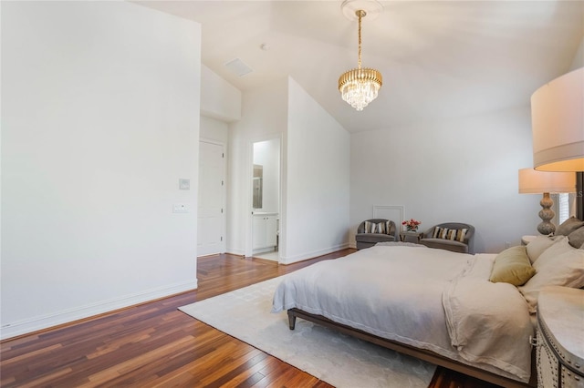 bedroom featuring a notable chandelier, baseboards, vaulted ceiling, and wood finished floors