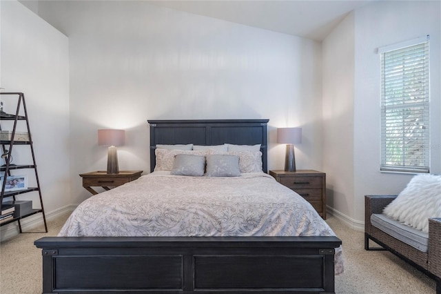 bedroom featuring vaulted ceiling and baseboards