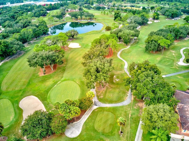 drone / aerial view with view of golf course and a water view