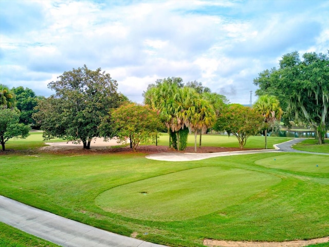 view of home's community with a lawn and golf course view