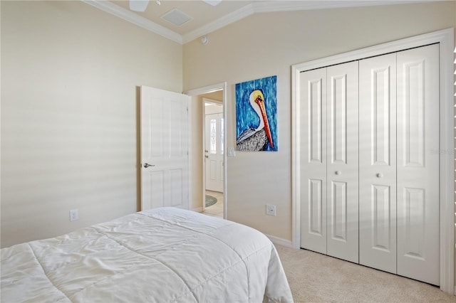 bedroom with visible vents, light carpet, a closet, crown molding, and vaulted ceiling