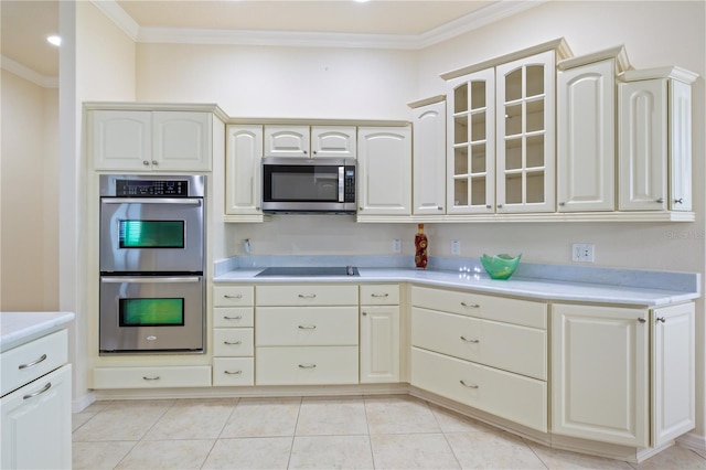 kitchen featuring light countertops, ornamental molding, glass insert cabinets, and stainless steel appliances