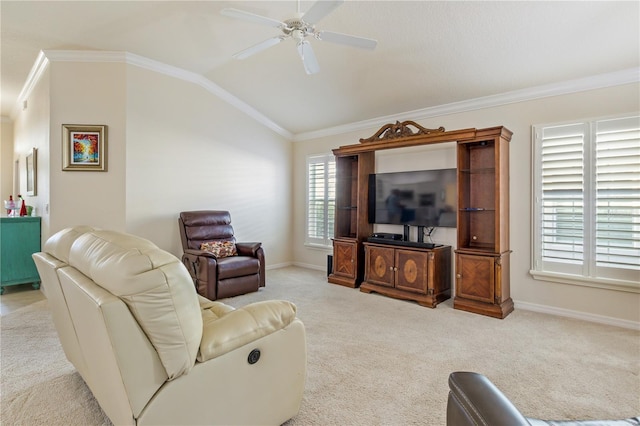 living area with a ceiling fan, carpet, baseboards, ornamental molding, and vaulted ceiling