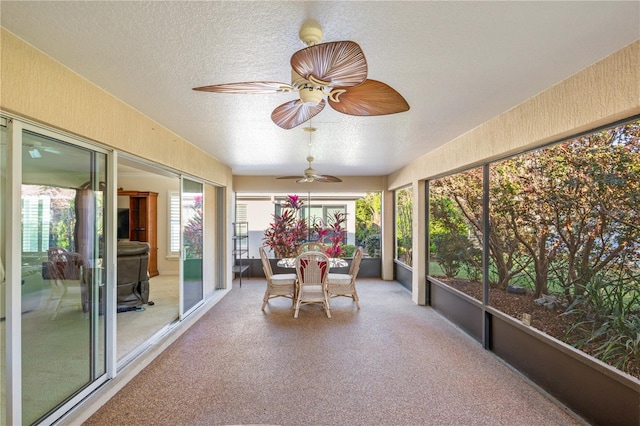 sunroom / solarium featuring a ceiling fan