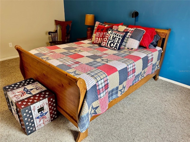 carpeted bedroom featuring baseboards