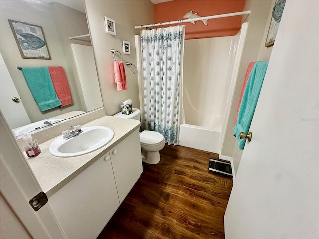 full bathroom with toilet, wood finished floors, vanity, visible vents, and shower / bath combo with shower curtain