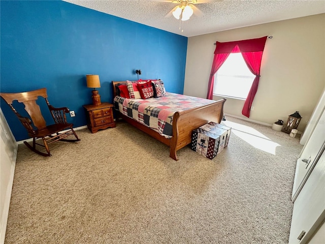 carpeted bedroom featuring ceiling fan, a textured ceiling, and baseboards