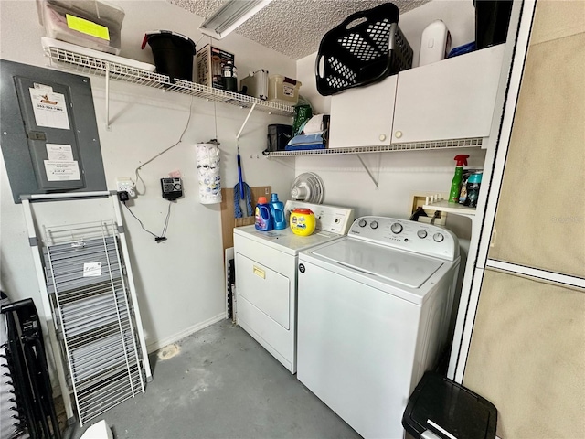 washroom featuring cabinet space and washer and clothes dryer