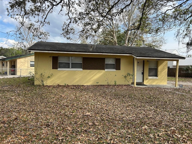 view of front of property with fence and stucco siding