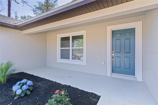 doorway to property with stucco siding