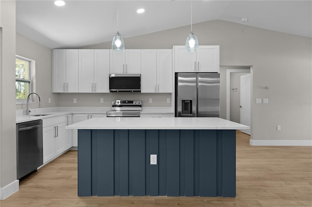 kitchen featuring a sink, white cabinets, light countertops, appliances with stainless steel finishes, and a center island