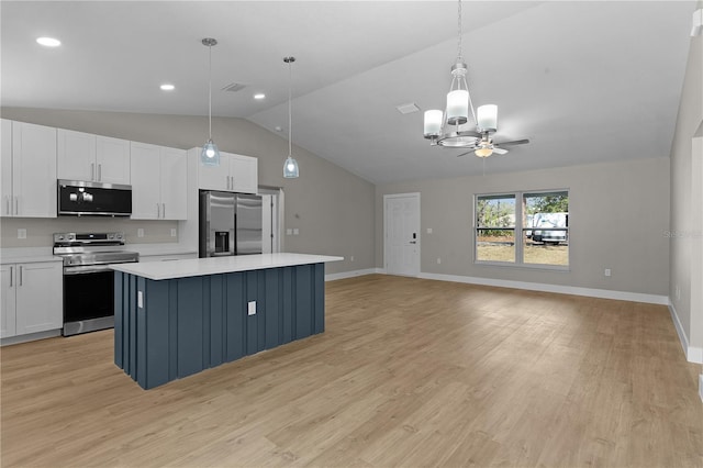 kitchen featuring light countertops, appliances with stainless steel finishes, white cabinetry, and a center island