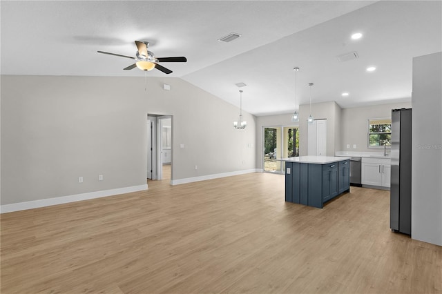 kitchen featuring visible vents, open floor plan, a center island, stainless steel appliances, and light countertops