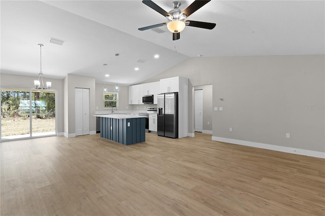 kitchen with light wood-style flooring, white cabinetry, light countertops, appliances with stainless steel finishes, and a center island