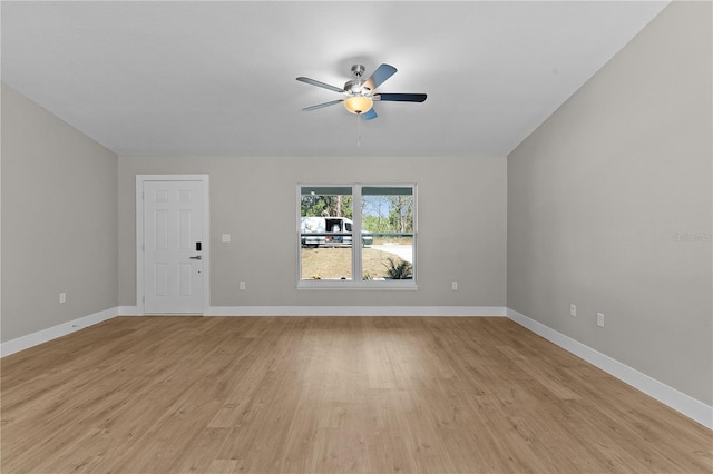 unfurnished living room featuring a ceiling fan, light wood-style flooring, and baseboards