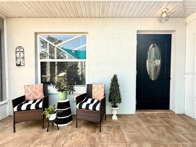 view of exterior entry featuring stucco siding