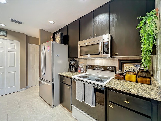 kitchen with decorative backsplash, appliances with stainless steel finishes, light stone countertops, visible vents, and recessed lighting
