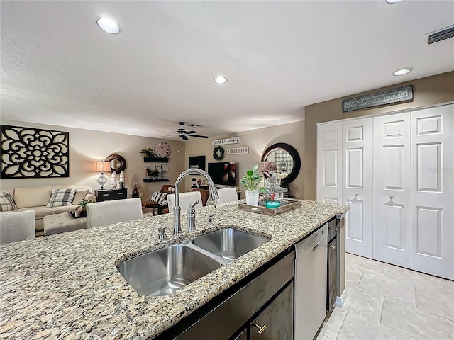 kitchen with a sink, open floor plan, dishwasher, ceiling fan, and visible vents