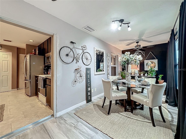 dining room with visible vents, baseboards, and ceiling fan