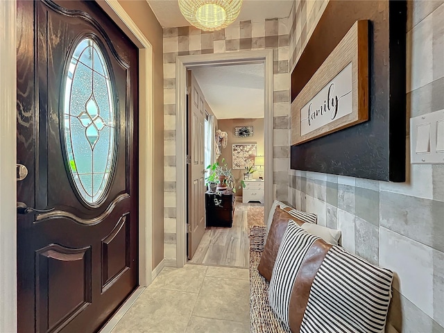 entryway featuring a chandelier and light tile patterned floors
