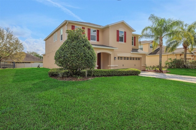 view of front of house with an attached garage, fence, concrete driveway, stucco siding, and a front yard