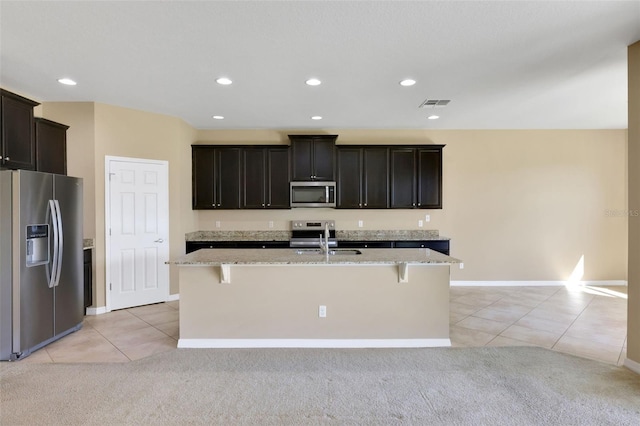 kitchen with appliances with stainless steel finishes, light carpet, visible vents, and light tile patterned floors