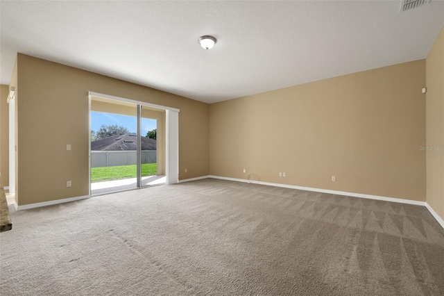 unfurnished room with visible vents, baseboards, and carpet flooring