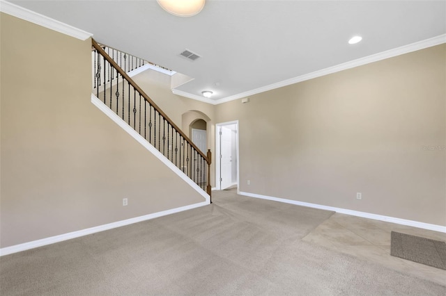 unfurnished room with baseboards, visible vents, arched walkways, stairway, and ornamental molding