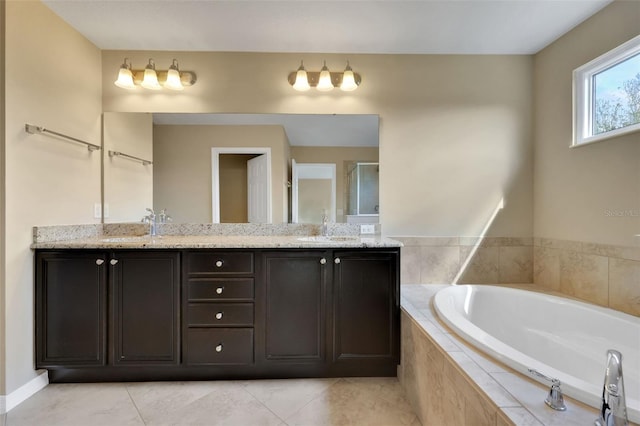 full bathroom with double vanity, a garden tub, a shower stall, and a sink