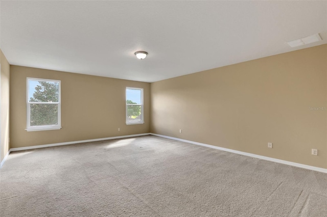 carpeted empty room with visible vents and baseboards