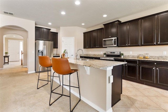 30342 Gidran Ter, Mount Dora, FL 32757 - kitchen featuring a sink, a kitchen breakfast bar, visible vents, arched walkways, and appliances with stainless steel finishes