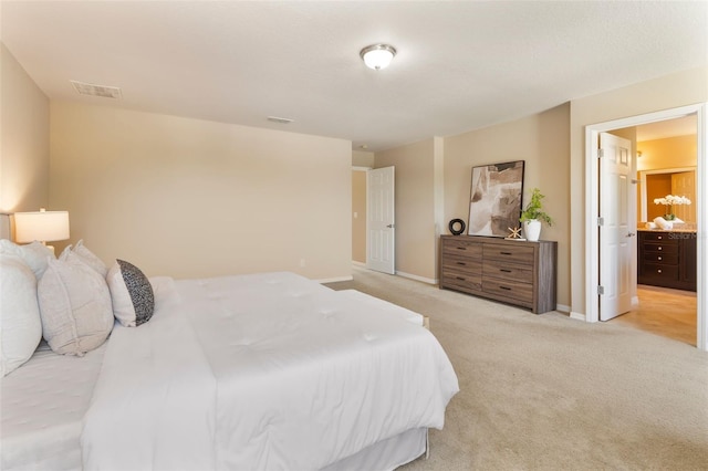 30342 Gidran Ter, Mount Dora, FL 32757 - bedroom with light colored carpet, connected bathroom, visible vents, and baseboards