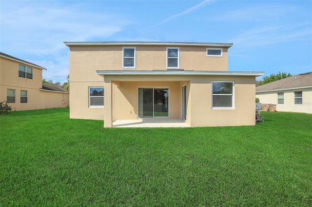 30342 Gidran Ter, Mount Dora, FL 32757 - back of property featuring a yard, a patio, and stucco siding