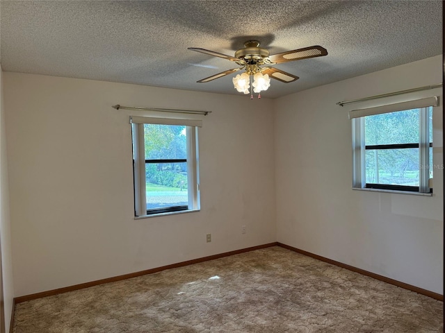 spare room featuring carpet, ceiling fan, a textured ceiling, and baseboards