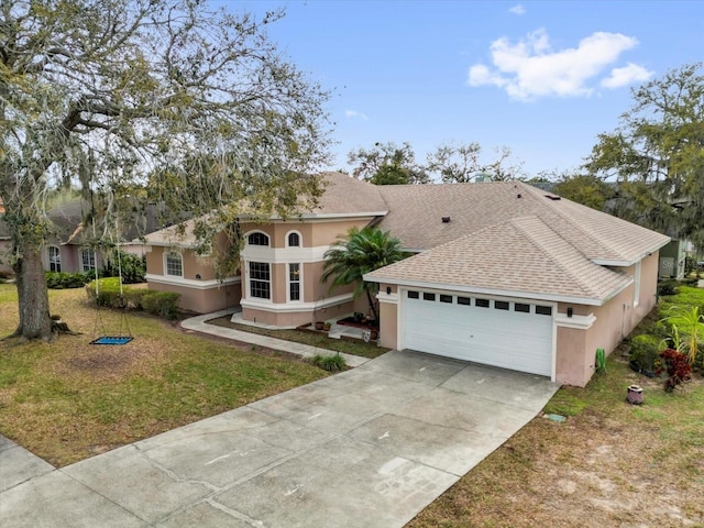 view of front of property featuring a shingled roof, driveway, an attached garage, and stucco siding