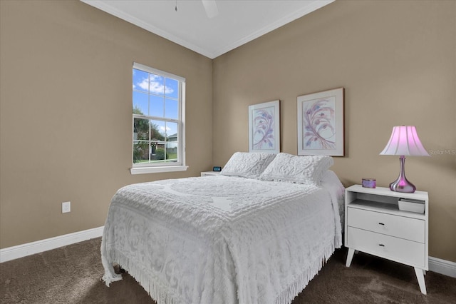 bedroom with a ceiling fan, baseboards, dark carpet, and crown molding