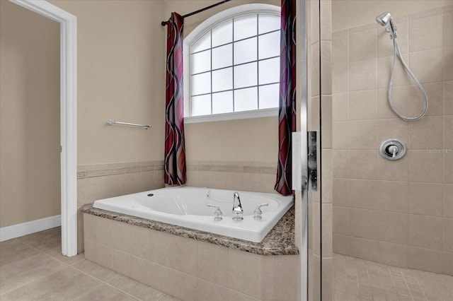 bathroom featuring a stall shower, a garden tub, and tile patterned floors