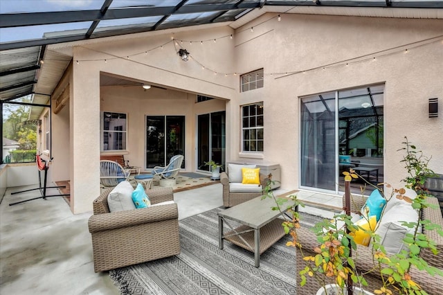 exterior space with glass enclosure and outdoor lounge area