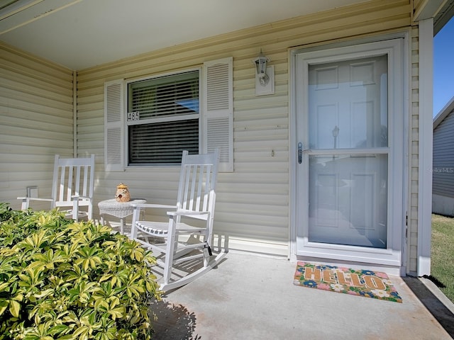 view of exterior entry featuring a porch