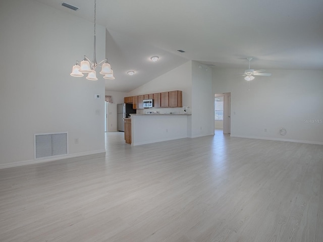 unfurnished living room with ceiling fan with notable chandelier, light wood finished floors, and visible vents