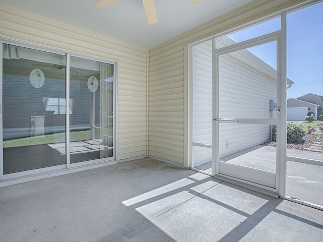 unfurnished sunroom with a ceiling fan