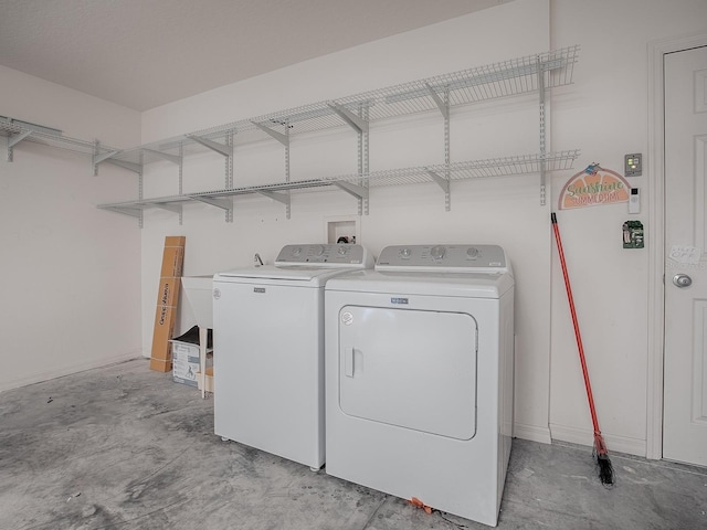 laundry area with laundry area and washer and clothes dryer