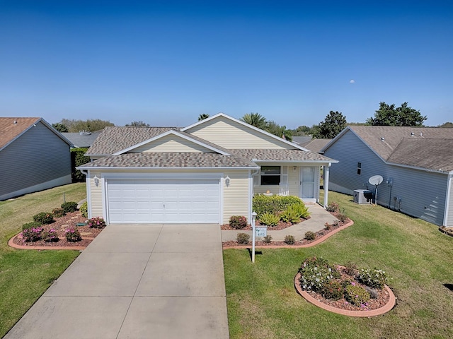 single story home featuring a garage, driveway, roof with shingles, and a front yard