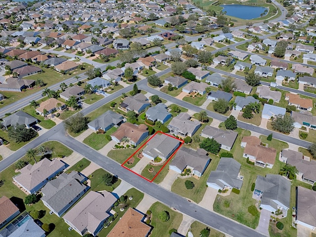 drone / aerial view with a water view and a residential view