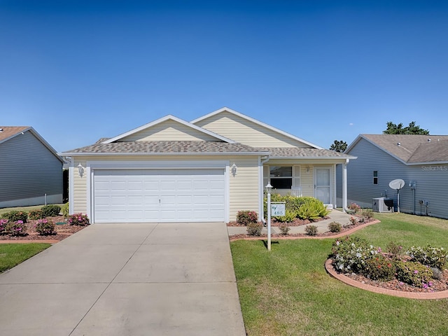 single story home featuring a shingled roof, a front yard, concrete driveway, and an attached garage