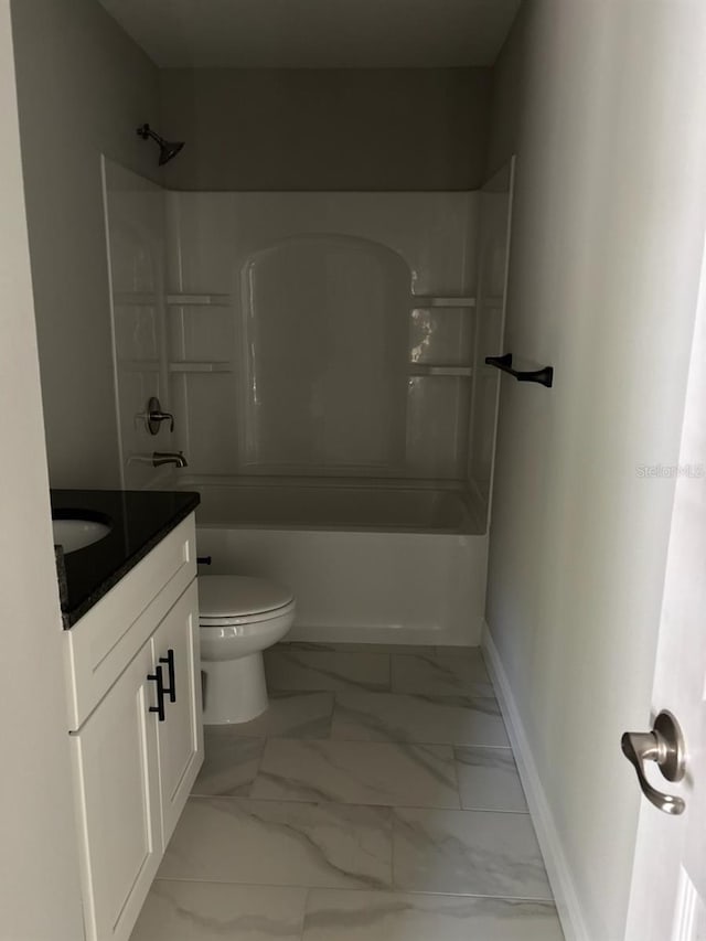 full bathroom featuring toilet, vanity, baseboards, marble finish floor, and tub / shower combination