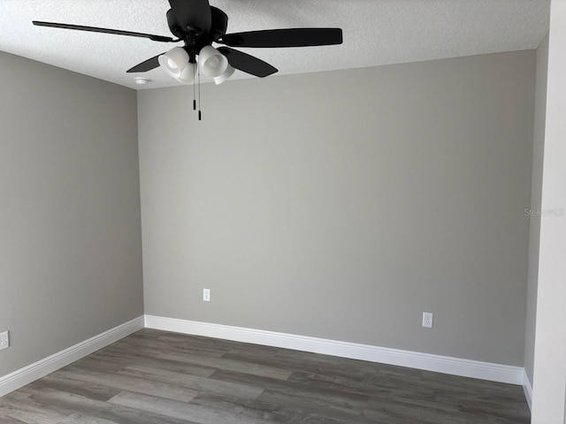 spare room with ceiling fan, a textured ceiling, baseboards, and wood finished floors