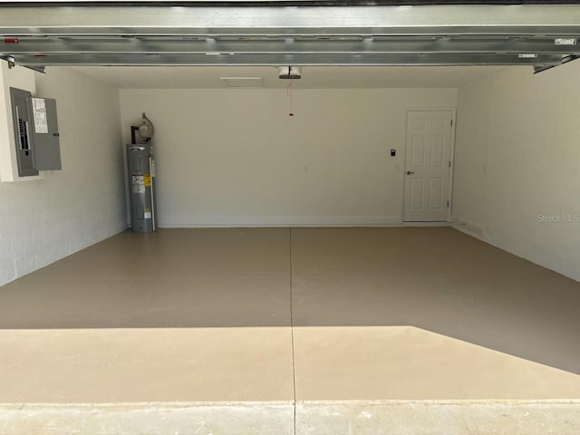 garage with a garage door opener, electric panel, and electric water heater