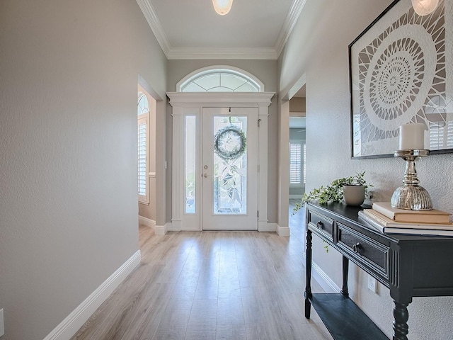 entryway featuring baseboards, ornamental molding, and wood finished floors