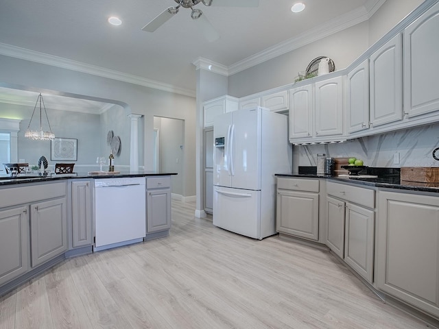 kitchen with white appliances, dark countertops, ceiling fan, ornamental molding, and light wood-type flooring